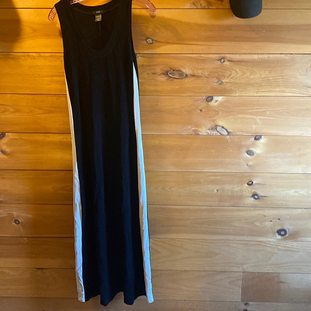 Fiore black dress with white stripes up the side. Stretchy material form fitting